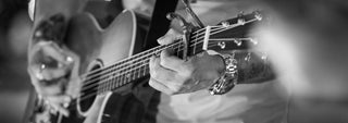 Close up of hands playing a guitar