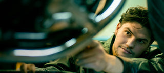 Guy changing oil on a motorcycle